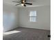 A bedroom featuring neutral walls, carpet, a ceiling fan and a window at 4756 Manly Ct, Stone Mountain, GA 30088