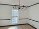 An empty dining room featuring wood-look floors, chandelier, and natural light at 4756 Manly Ct, Stone Mountain, GA 30088