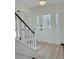 Bright foyer with stylish front door and staircase, showcasing modern flooring and fresh paint at 4756 Manly Ct, Stone Mountain, GA 30088