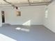 Clean, bright garage with white walls, gray floor, and overhead storage at 4756 Manly Ct, Stone Mountain, GA 30088
