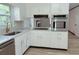 Beautiful kitchen with stainless steel appliances, white cabinets, quartz countertops, and modern fixtures at 4756 Manly Ct, Stone Mountain, GA 30088