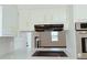 Modern kitchen featuring sleek countertops, updated appliances, and a view into the adjacent living space at 4756 Manly Ct, Stone Mountain, GA 30088