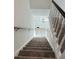 Carpeted staircase with white railing leading to front door at 4756 Manly Ct, Stone Mountain, GA 30088