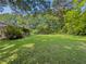 Expansive backyard with lush green grass and mature trees surrounding the property at 2000 Stone Mountain Lithonia Rd, Lithonia, GA 30058