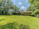Grassy lawn and large trees create a tranquil backyard setting at 2000 Stone Mountain Lithonia Rd, Lithonia, GA 30058