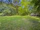 Spacious backyard with lush green grass and mature trees, perfect for outdoor activities at 2000 Stone Mountain Lithonia Rd, Lithonia, GA 30058