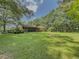 Expansive lawn and screened porch highlight this home's outdoor living appeal at 2000 Stone Mountain Lithonia Rd, Lithonia, GA 30058