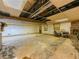 Unfinished basement with exposed ceiling, brick fireplace, and concrete floor at 2000 Stone Mountain Lithonia Rd, Lithonia, GA 30058