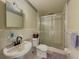 Tiled bathroom featuring a vanity, toilet, and glass-enclosed shower at 2000 Stone Mountain Lithonia Rd, Lithonia, GA 30058