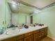 Bathroom featuring an expansive vanity with wood cabinets and a large mirror at 2000 Stone Mountain Lithonia Rd, Lithonia, GA 30058