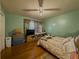 Comfortable bedroom with hardwood floors, fan, and a cozy bed at 2000 Stone Mountain Lithonia Rd, Lithonia, GA 30058