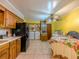 Kitchen area with laundry machines, wood cabinets, and tile flooring at 2000 Stone Mountain Lithonia Rd, Lithonia, GA 30058