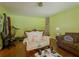 Living room with wood floors, cozy seating, and bright green walls at 2000 Stone Mountain Lithonia Rd, Lithonia, GA 30058