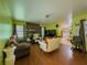 Spacious living room with fireplace, wood floors, and view to kitchen at 2000 Stone Mountain Lithonia Rd, Lithonia, GA 30058