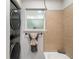 An updated bathroom showcases a stackable washer/dryer, window, tile accents, and a tub at 3149 Buford Hwy # 3, Brookhaven, GA 30329