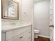 A clean half bathroom featuring a white vanity and a toilet, with neutral wall paint at 3149 Buford Hwy # 3, Brookhaven, GA 30329