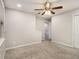 An empty bedroom features neutral carpet, gray walls, a window, a ceiling fan, and a closet at 3149 Buford Hwy # 3, Brookhaven, GA 30329