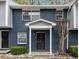 Close-up of townhome entrance featuring a black door, white trim, and stone landscaping at 3149 Buford Hwy # 3, Brookhaven, GA 30329