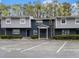 Two-story condo building with reserved parking spaces and a combination brick and siding facade at 3149 Buford Hwy # 3, Brookhaven, GA 30329