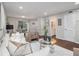 Open-concept living room with hardwood floors, modern decor, and access to the dining area at 3149 Buford Hwy # 3, Brookhaven, GA 30329