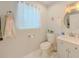 Clean bathroom features a round mirror, toilet, and sink at 377 Wyndham Way, Atlanta, GA 30315