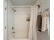 A bright bathroom showcasing a bathtub and a tiled shower with neutral accents at 377 Wyndham Way, Atlanta, GA 30315