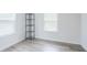 This bedroom features gray wood floors, a metal shelf, and two windows at 377 Wyndham Way, Atlanta, GA 30315
