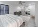Well-lit bedroom featuring a striped bedding set and sliding barn door at 377 Wyndham Way, Atlanta, GA 30315