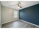 This bedroom offers a neutral color palette, with a ceiling fan and a large window at 377 Wyndham Way, Atlanta, GA 30315