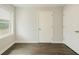 A bedroom with wood floors, a window, and two white doors at 377 Wyndham Way, Atlanta, GA 30315