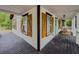 Corner view of a spacious front porch with white railings and decorative wooden shutters at 377 Wyndham Way, Atlanta, GA 30315