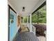 Cozy front porch with rocking chairs, white columns, and a dark-stained wooden floor at 377 Wyndham Way, Atlanta, GA 30315