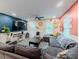 Spacious living room with a sectional sofa, entertainment center, and seamless flow to the dining area at 377 Wyndham Way, Atlanta, GA 30315
