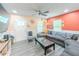Bright and airy living room featuring a gray sectional, accent seating, and a view of the entrance at 377 Wyndham Way, Atlanta, GA 30315