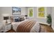 This bedroom features a comfortable bed, stylish decor, and natural light from the two windows at 53 Springside Se Dr, Atlanta, GA 30354