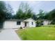 Charming renovated single-story home with a well-manicured front lawn and black trimmed windows at 53 Springside Se Dr, Atlanta, GA 30354