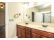 Bathroom featuring dual sinks, granite countertops, and decorative mirrors at 610 Sunflower Dr, Canton, GA 30114