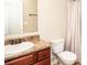 Traditional bathroom with wooden vanity, sink, mirror, toilet and shower at 610 Sunflower Dr, Canton, GA 30114