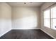 Bright bedroom features dark wood floors, neutral walls, and natural light from the double window at 610 Sunflower Dr, Canton, GA 30114