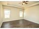 Inviting bedroom featuring a tray ceiling, neutral paint, ceiling fan and two sun-filled windows at 610 Sunflower Dr, Canton, GA 30114