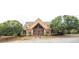 Exterior view of the community clubhouse with a manicured lawn and mature trees at 610 Sunflower Dr, Canton, GA 30114