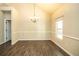 Bright dining room featuring wood-look flooring, natural light, and a contemporary chandelier at 610 Sunflower Dr, Canton, GA 30114