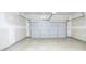 An empty garage with a gray concrete floor and a gray insulated garage door at 610 Sunflower Dr, Canton, GA 30114