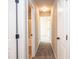 Hallway with carpet flooring and doors leading to various rooms in the home at 610 Sunflower Dr, Canton, GA 30114