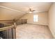 Spacious loft area with carpeting, ceiling fan, and wooden railing, perfect for relaxing at 610 Sunflower Dr, Canton, GA 30114