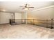 The cozy upstairs loft features carpeting, ceiling fan, and dark wooden railing overlooking the stairs at 610 Sunflower Dr, Canton, GA 30114