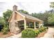 Community pavilion with an outdoor stone fireplace, picnic tables, and ceiling fans at 610 Sunflower Dr, Canton, GA 30114