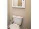 Powder room with a white toilet and a mirror above the toilet at 610 Sunflower Dr, Canton, GA 30114