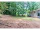 This home has a large partially grassed backyard that is surrounded by trees at 881 Mercury Nw Dr, Atlanta, GA 30331