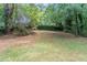 This home features a large backyard surrounded by many trees at 881 Mercury Nw Dr, Atlanta, GA 30331